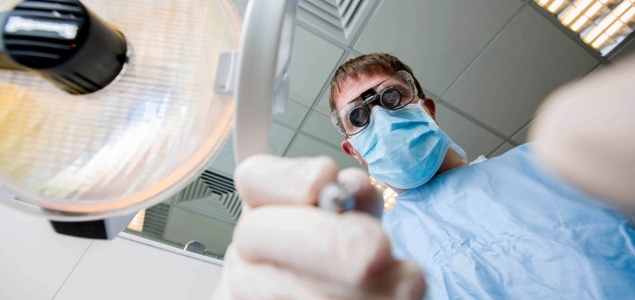 Dentist leaning over a patient
